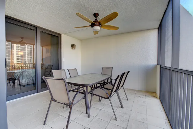 a view of a dining room with furniture and a ceiling fan