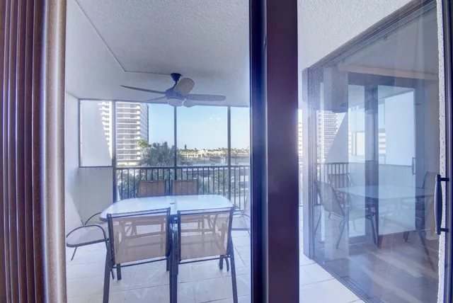 a view of a hallway with furniture and wooden floor