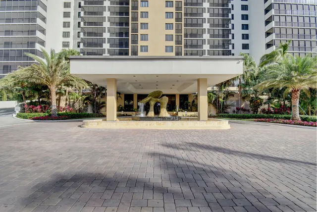 a front view of building with cars parked