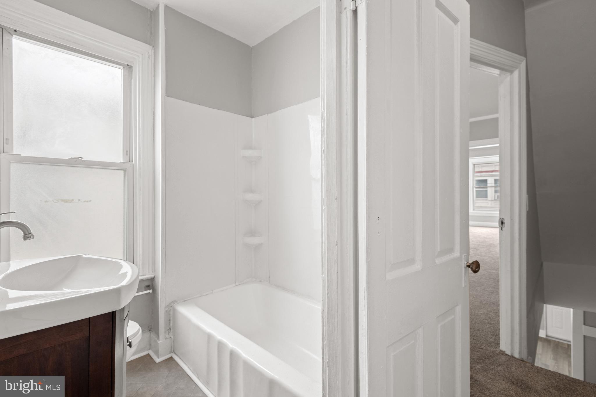 958 East Princess Street York, PA 17403 - Photo 19 of 27 a bathroom with a tub sink and mirror