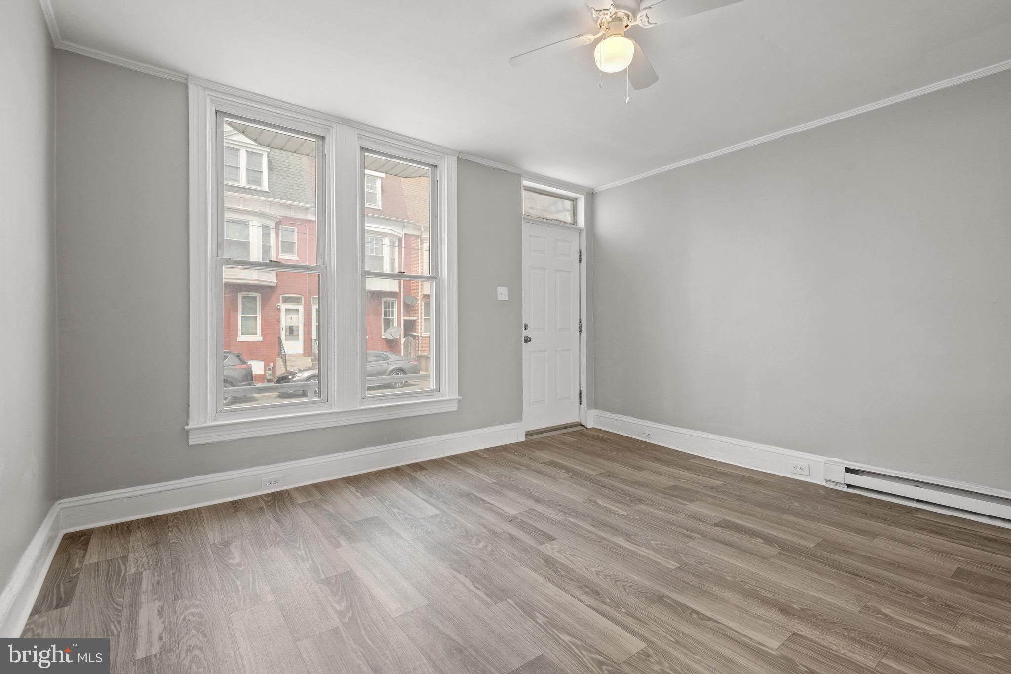 958 East Princess Street York, PA 17403 - Photo 4 of 27 a view of an empty room with wooden floor and a window