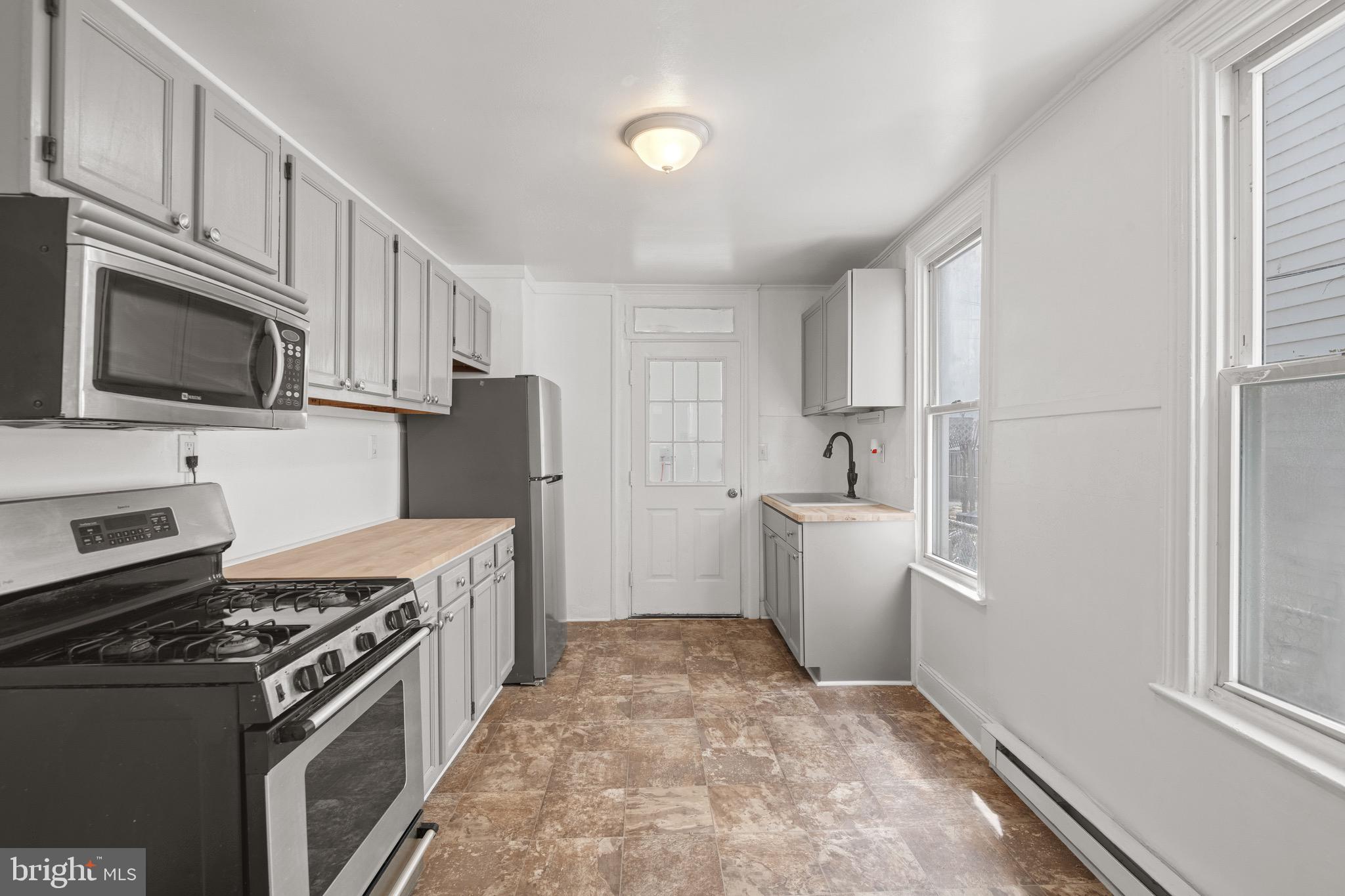 958 East Princess Street York, PA 17403 - Photo 7 of 27 a kitchen with a stove a sink and a refrigerator