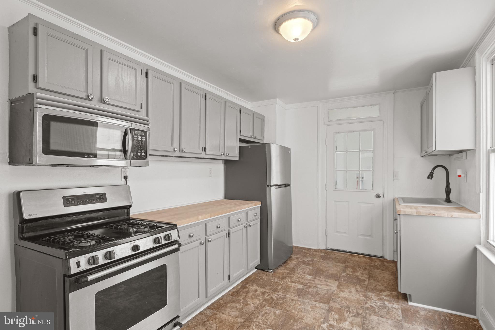 958 East Princess Street York, PA 17403 - Photo 8 of 27 a kitchen with white cabinets and stainless steel appliances
