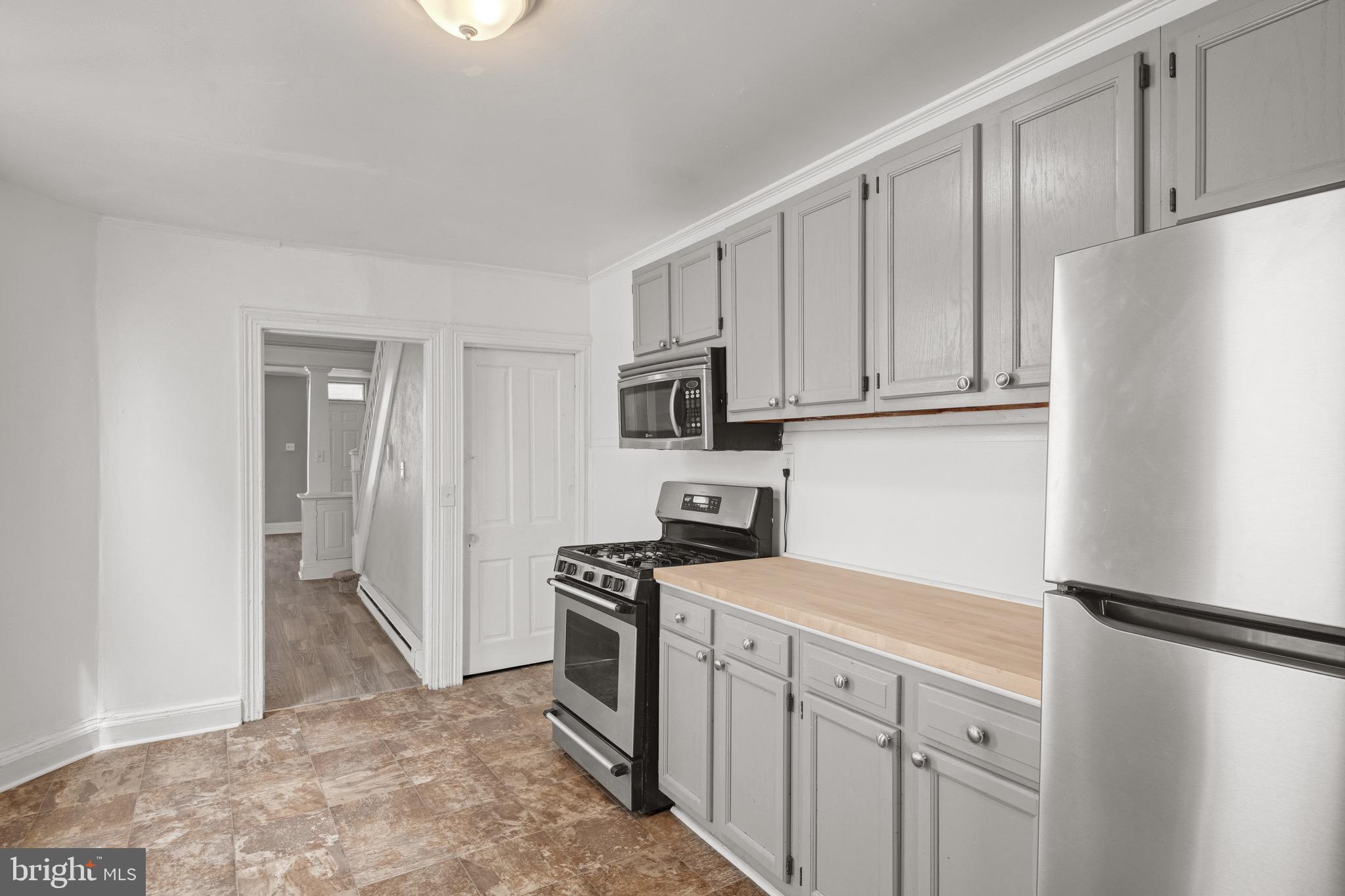 958 East Princess Street York, PA 17403 - Photo 10 of 27 a kitchen with stainless steel appliances a refrigerator stove and cabinets