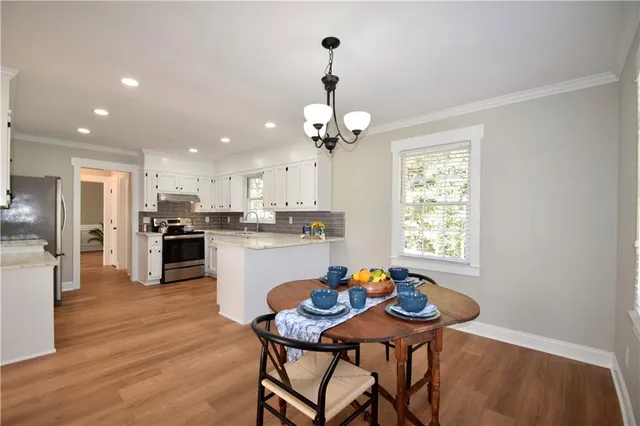 a kitchen with a table and chairs in it