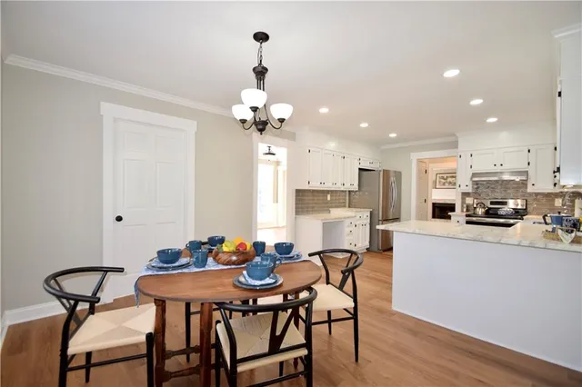 a view of a dining room with furniture and wooden floor