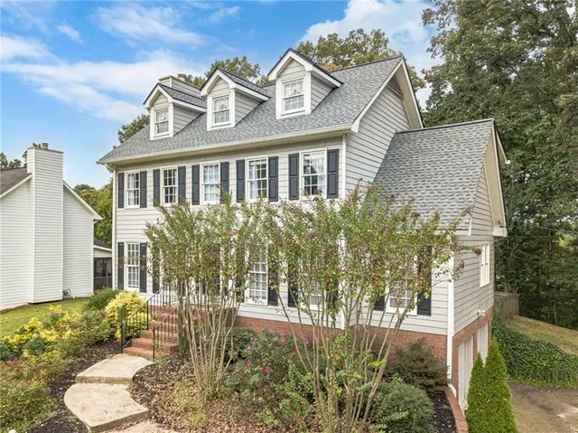 a front view of a house with a garden
