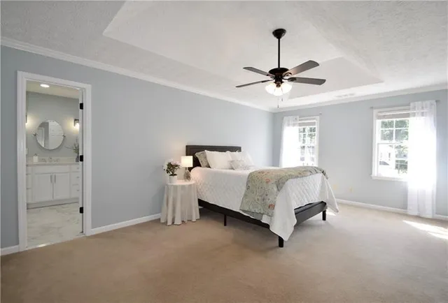 a spacious bedroom with a bed and a ceiling fan