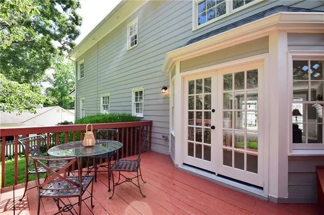 a view of a chairs and table on the wooden deck