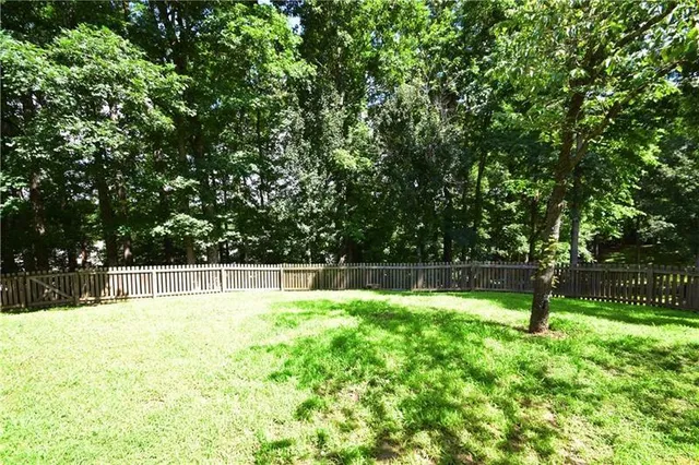 a backyard of a house with a swing and slide