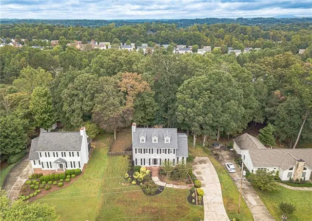 a front view of a building with a garden