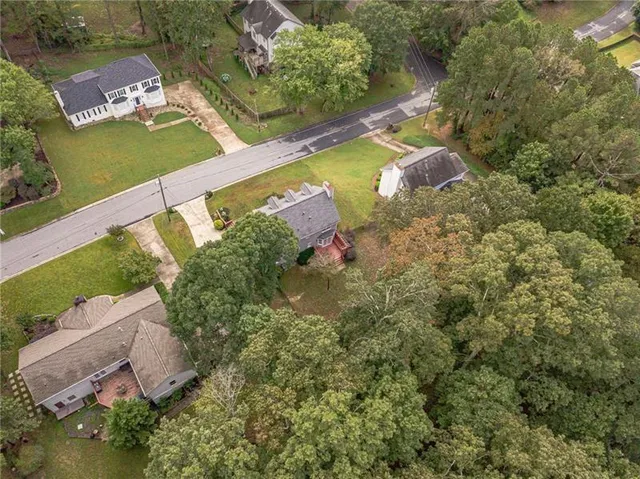 an aerial view of a house with a yard