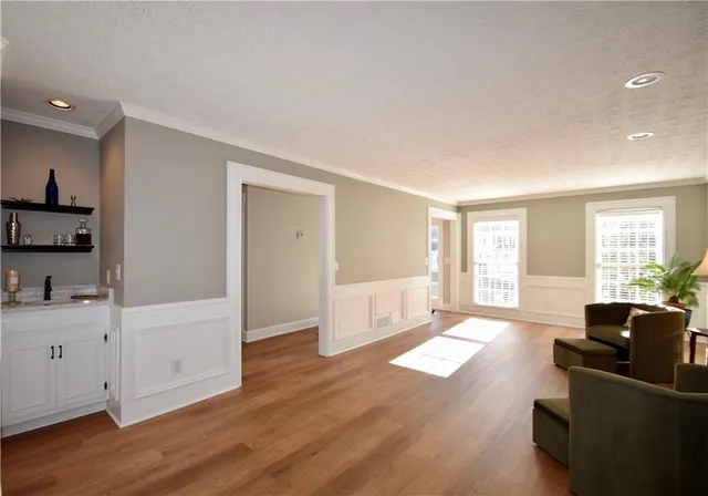 a living room with furniture window and wooden floor