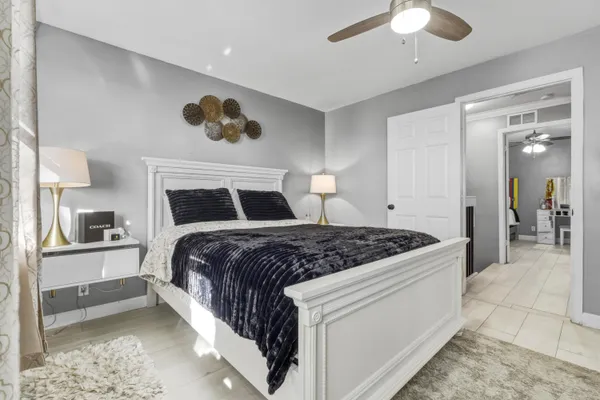 a bedroom with a bed and a chandelier