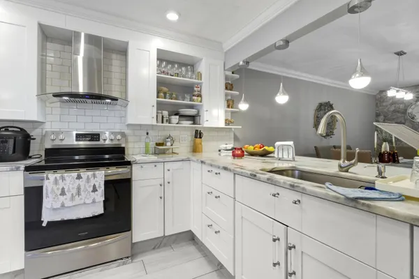 a kitchen with stainless steel appliances granite countertop a sink and cabinets