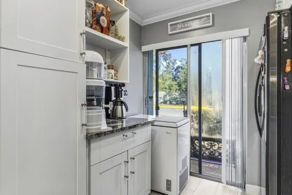 a room with a sink window and cabinets