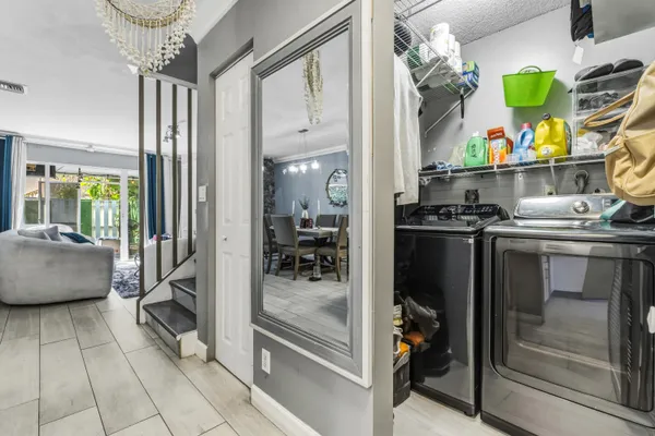 a kitchen with stainless steel appliances granite countertop a sink and a refrigerator