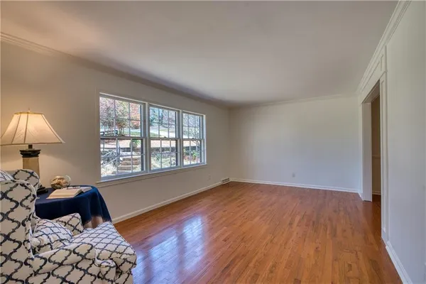 a bedroom with a bed lamp on table and a window