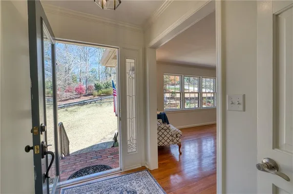 a view of a hallway with wooden floor and glass door