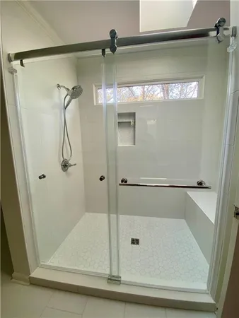 a bathroom with a glass shower door