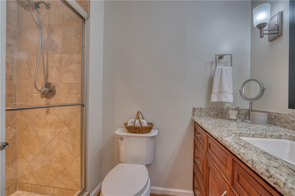 4 Wayne Street Rome, GA 30165 - Photo 28 of 51 a bathroom with a granite countertop sink a toilet and mirror