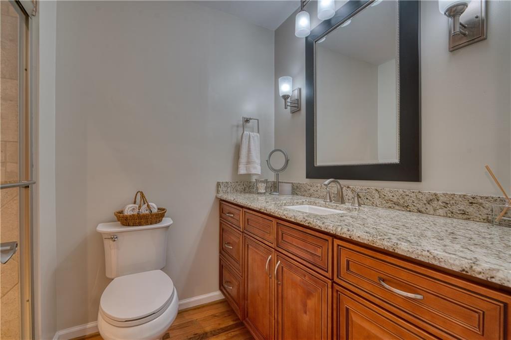 4 Wayne Street Rome, GA 30165 - Photo 29 of 51 a bathroom with a granite countertop toilet sink and mirror