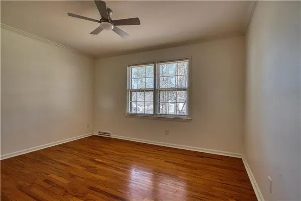 wooden floor in an empty room with a window