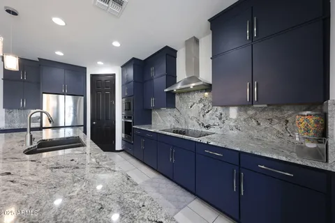 a kitchen with granite countertop wooden cabinets and a sink