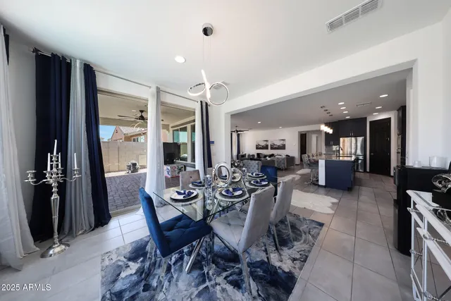 a living room with furniture and large windows