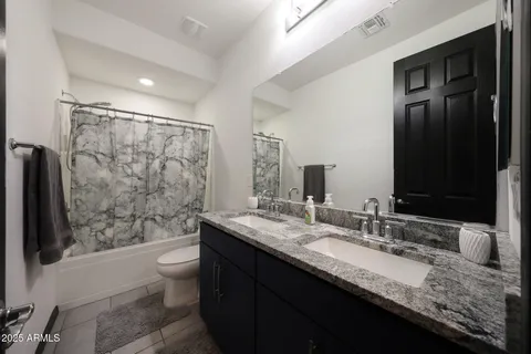 a view of a hallway with workspace and a window