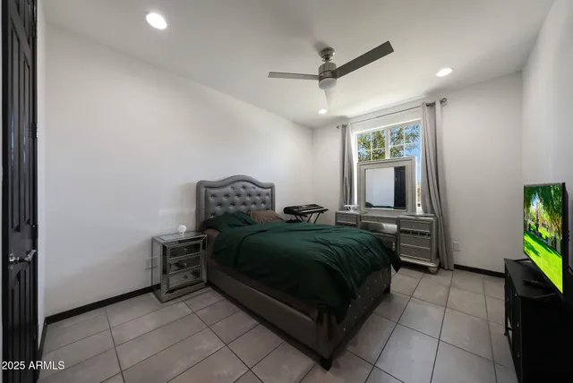 a bathroom with a granite countertop sink a toilet a mirror and shower