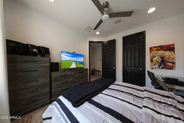 a bedroom with a bed and a television