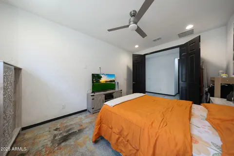 a bedroom with a bed and a view of closet