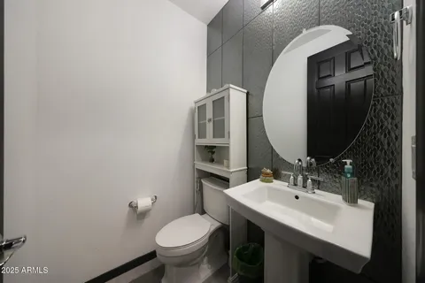 a bed room with a bed mirror and a flat tv screen