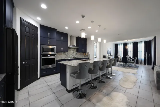 a large kitchen with a large counter top stainless steel appliances and cabinets