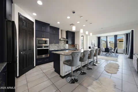 a large kitchen with kitchen island stainless steel appliances a sink and counter space