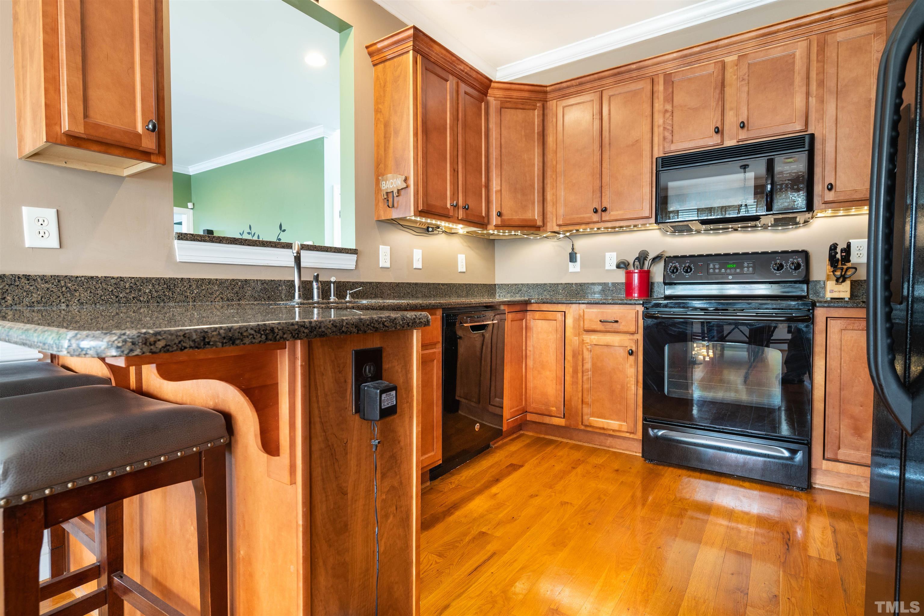 3216 Pat Tilley Road Bahama, NC 27503 - Photo 8 of 45 a kitchen with granite countertop a stove and a sink
