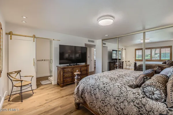 a bedroom with a bed and a flat screen tv