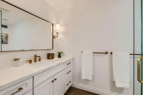 a bathroom with a sink and mirror
