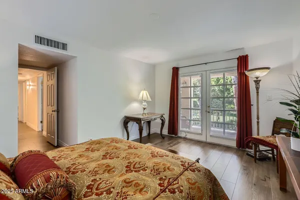 a bedroom with a bed and a large window with outer view