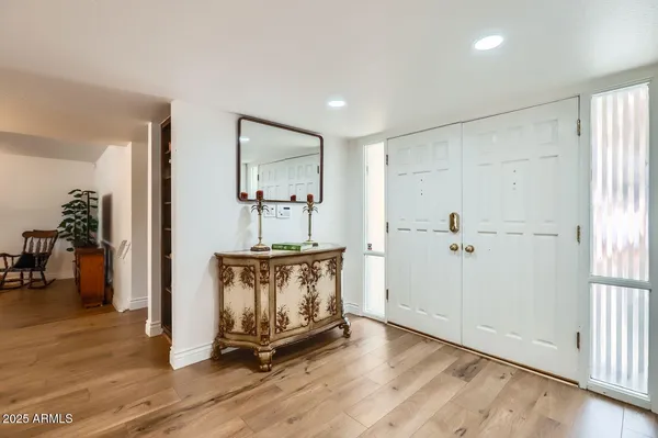 a view of an entryway with wooden floor