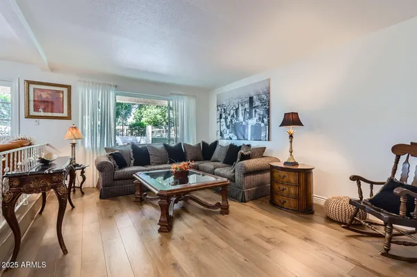 a living room with furniture and a wooden floor