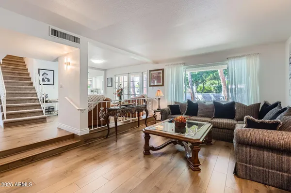 a living room with furniture and a wooden floor