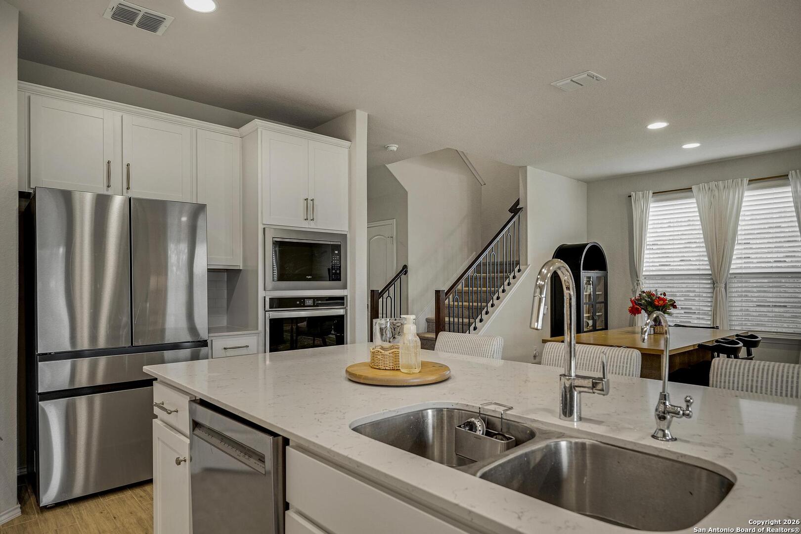 151 Inverness Boerne, TX 78015 - Photo 11 of 31 a kitchen with stainless steel appliances a sink a stove and a refrigerator