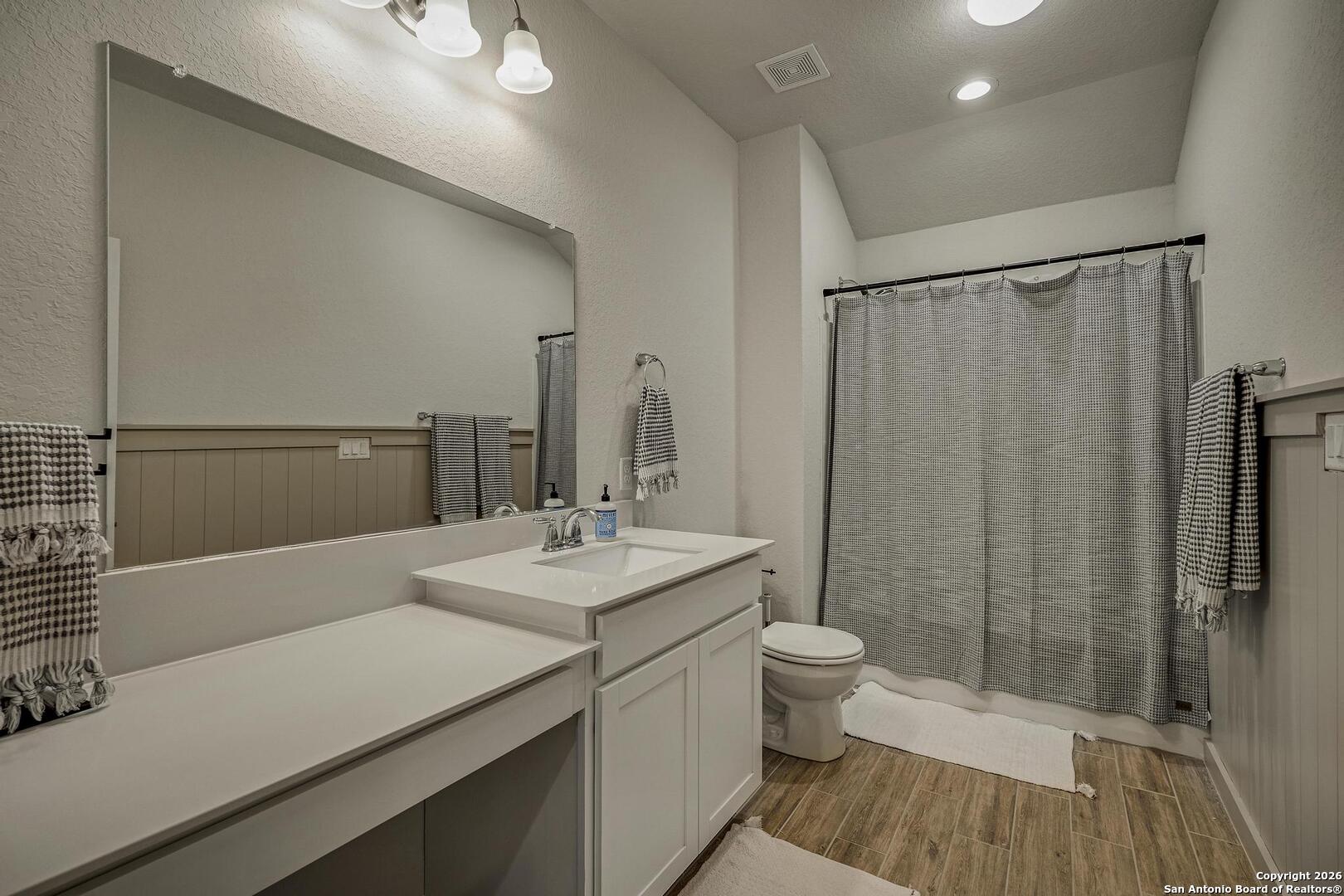 151 Inverness Boerne, TX 78015 - Photo 23 of 31 a bathroom with a sink a toilet a mirror and shower