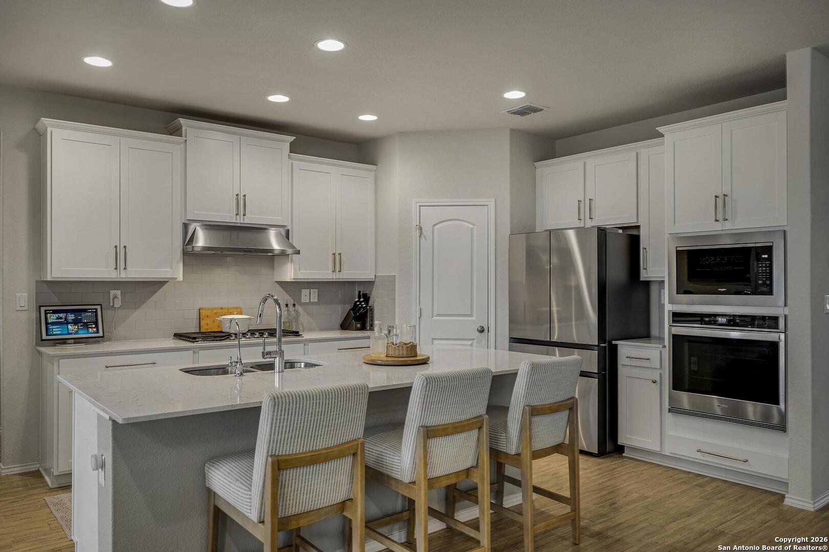 151 Inverness Boerne, TX 78015 - Photo 8 of 31 a kitchen with a sink cabinets and stainless steel appliances