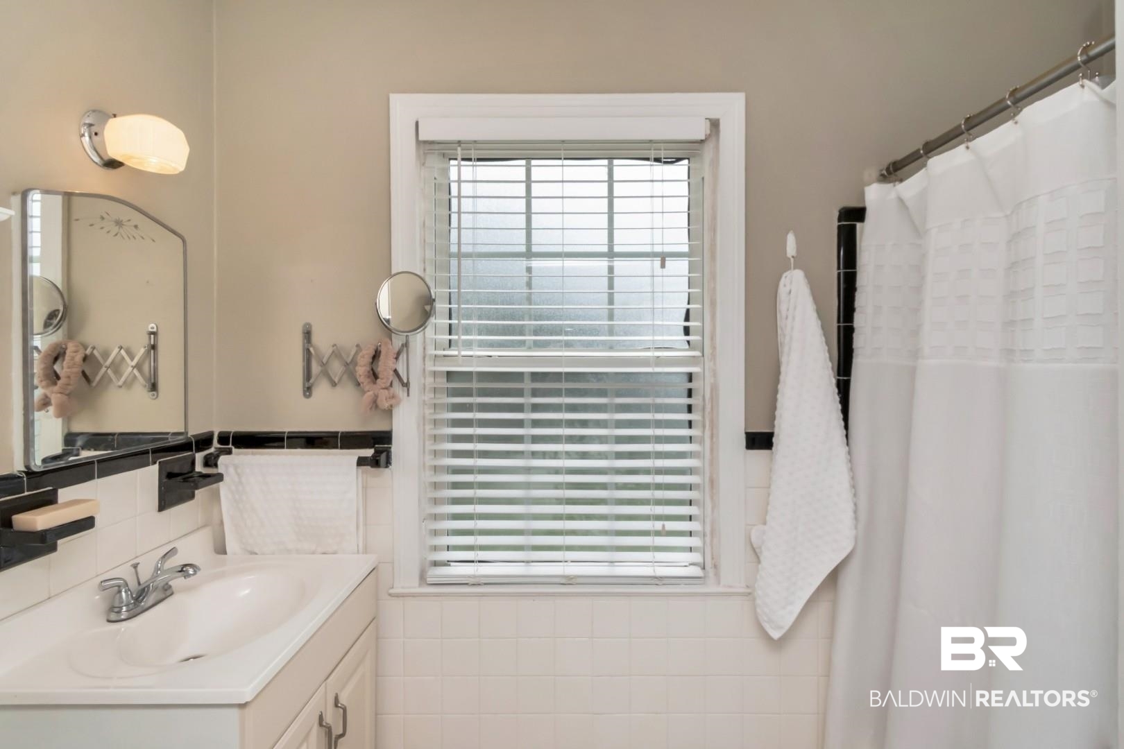 214 Upham Street, Unit 17C Mobile, AL 36607 - Photo 28 of 32 Full bath featuring vanity, curtained shower, tile walls, and wainscoting