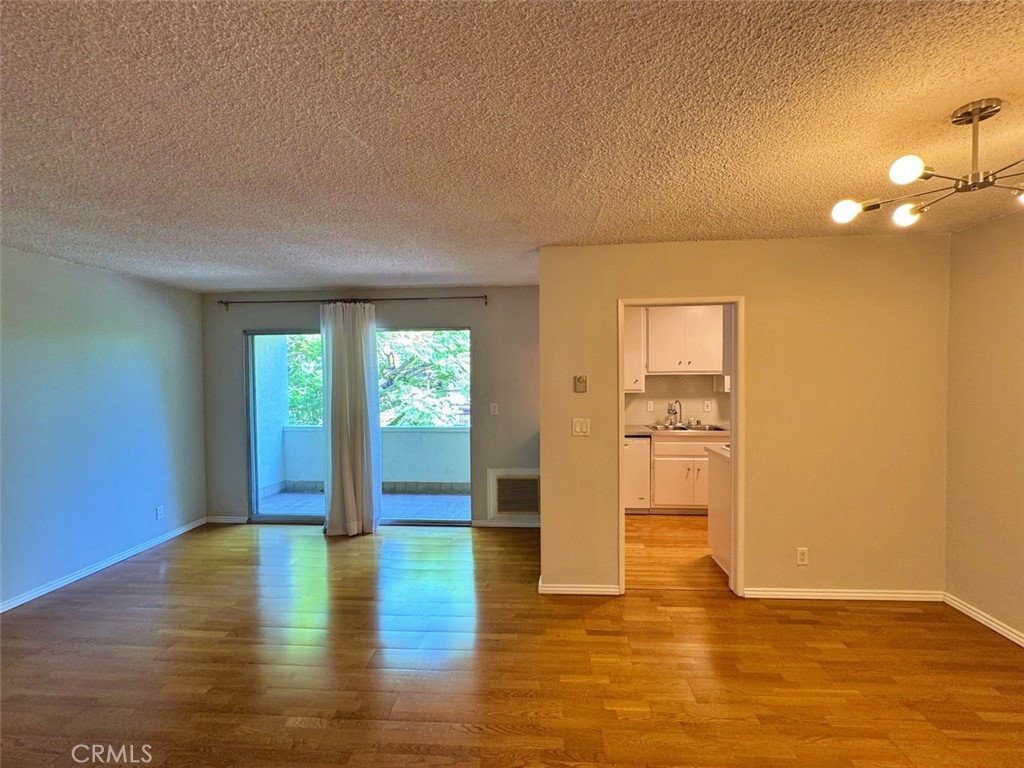 5625 North Sumner Way, Unit 212 Culver City, CA 90230 - Photo 15 of 39 a view of an empty room with window and wooden floor