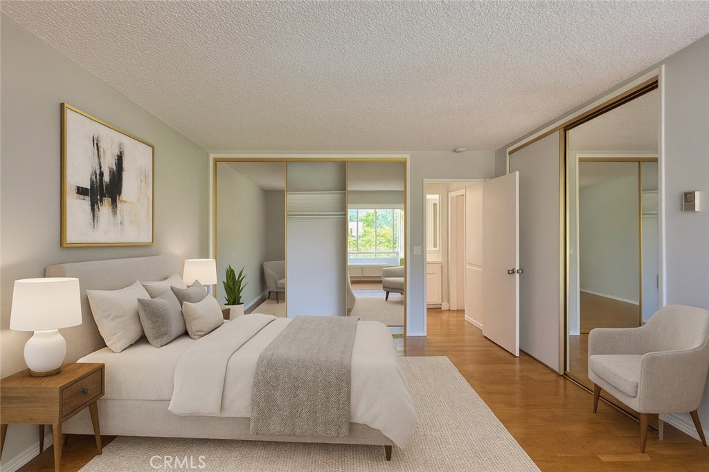5625 North Sumner Way, Unit 212 Culver City, CA 90230 - Photo 16 of 39 a spacious bedroom with a bed and a painting on the wall