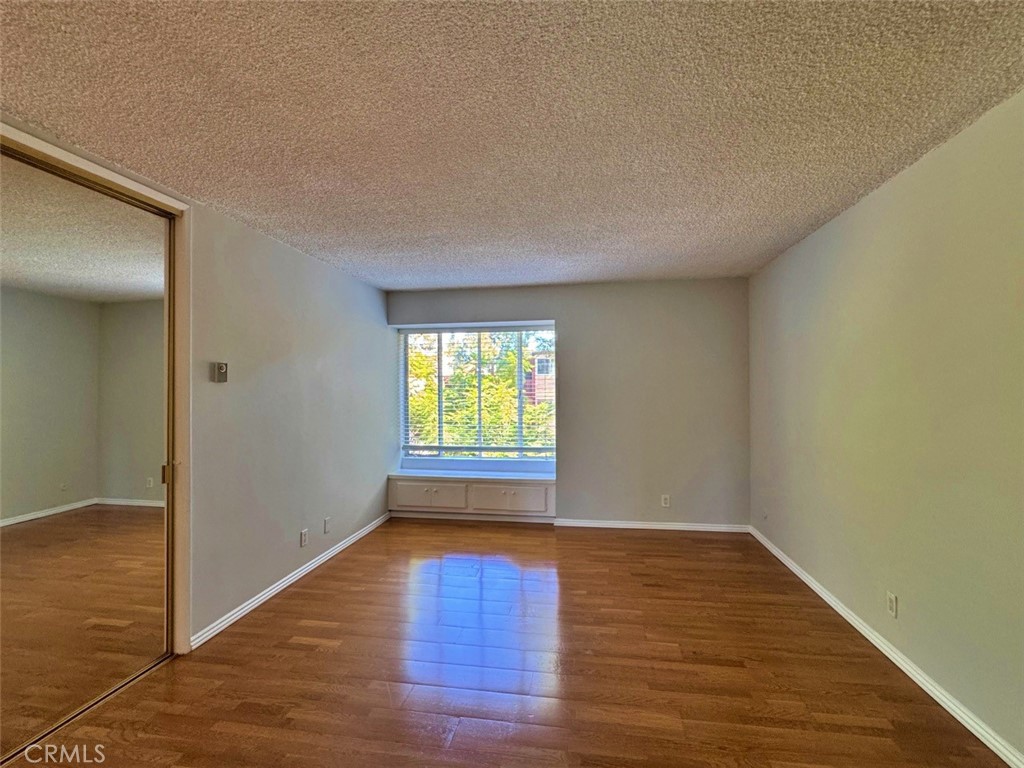 5625 North Sumner Way, Unit 212 Culver City, CA 90230 - Photo 22 of 39 a view of empty room with wooden floor and fan
